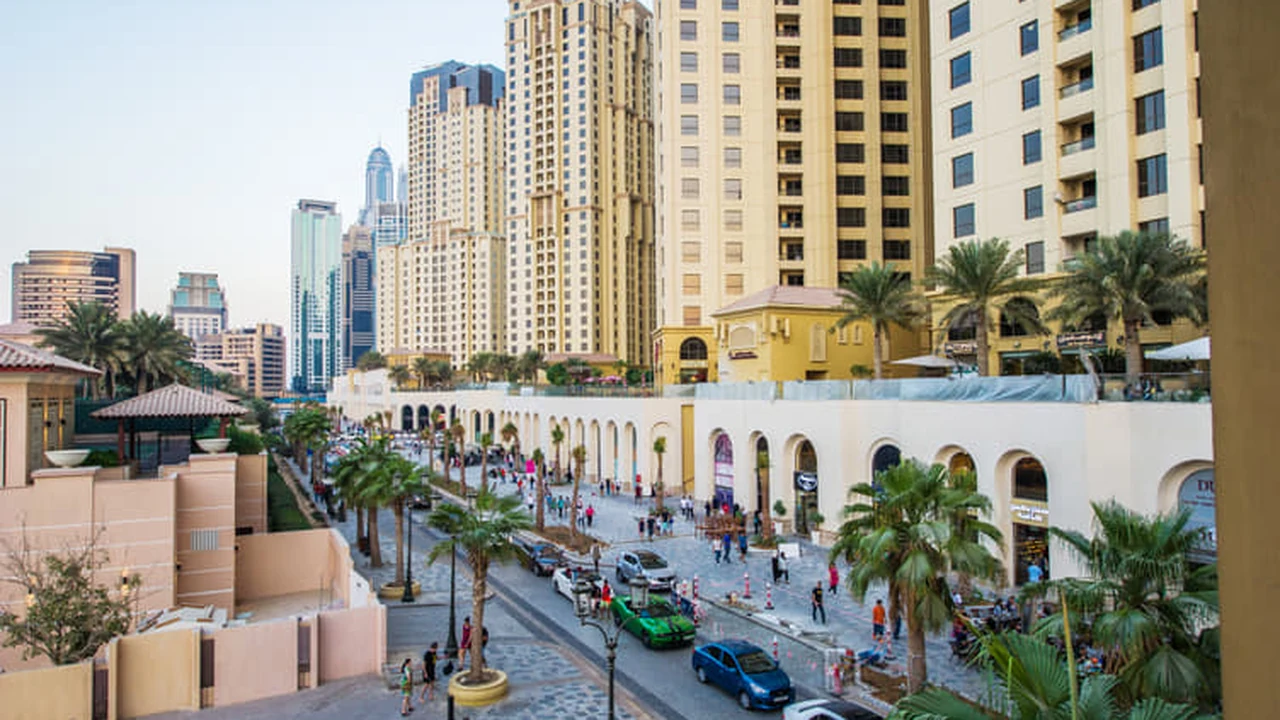 The Walk at JBR with restaurant terraces, palm trees and residential towers along the promenade