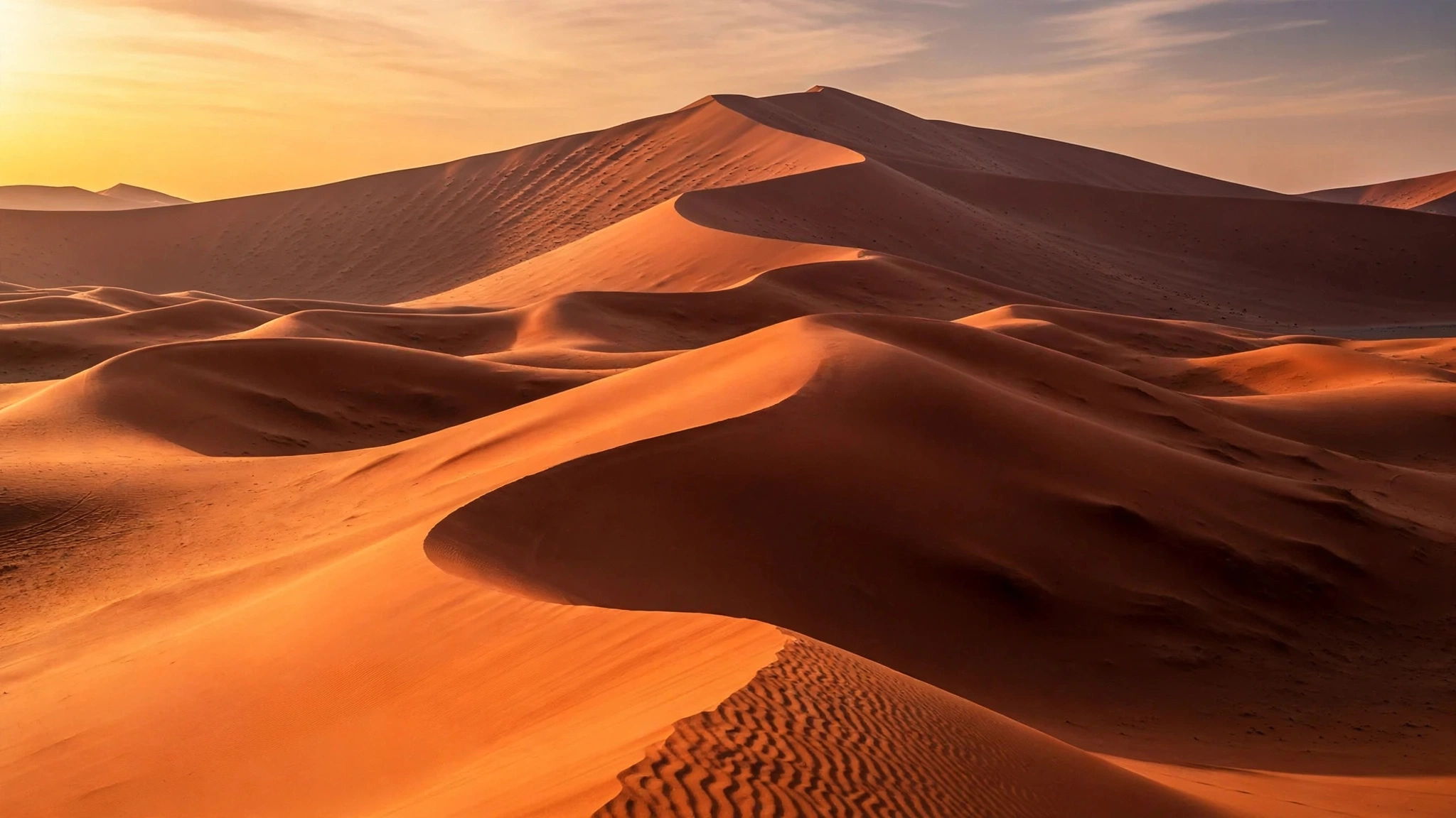 Vast Lahbab red dunes glowing at golden hour in the Dubai desert