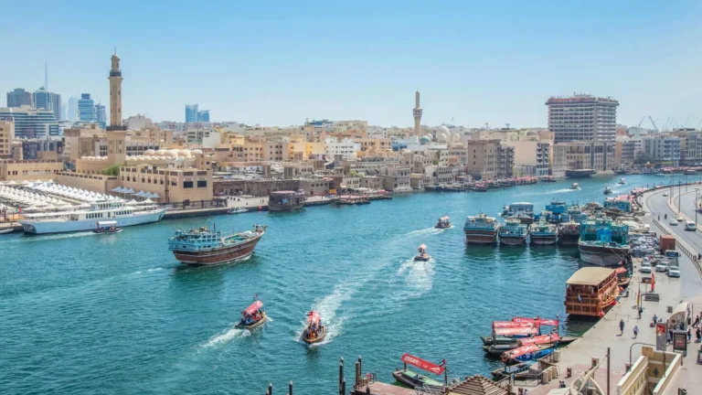 Traditional abras and cargo dhows on Dubai Creek in front of Bur Dubai