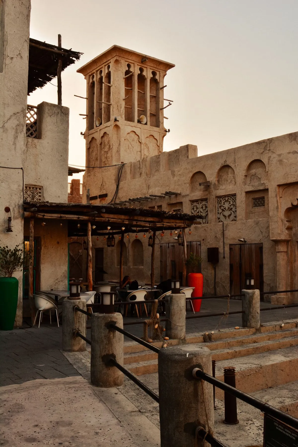 Wind tower houses and a shaded courtyard café in Al Fahidi, old Dubai
