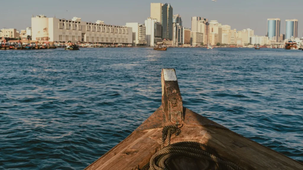 Bow of a traditional abra on Dubai Creek with the Deira waterfront, old Dubai