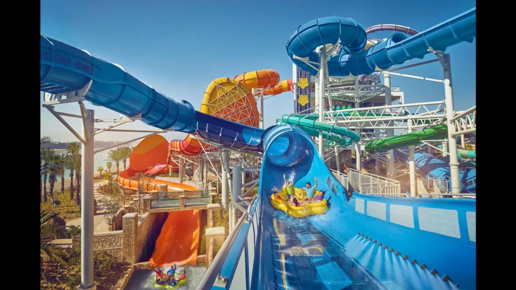 Colourful tower slides with riders at Aquaventure Waterpark on Palm Jumeirah, entry covered by aquaventure waterpark tickets