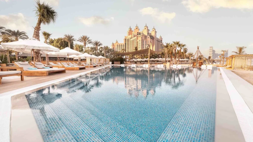 White Beach Dubai infinity pool and cabanas at Atlantis The Palm at golden hour