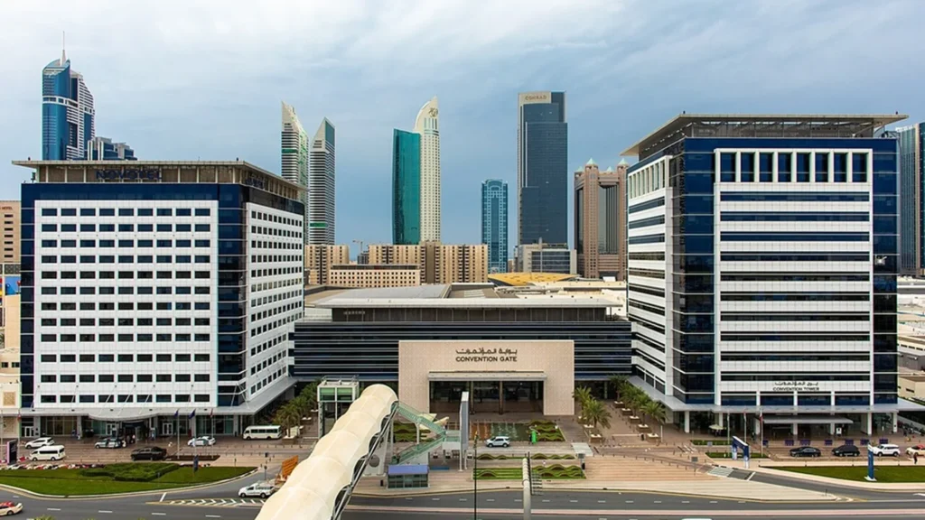 Dubai World Trade Centre Sheikh Rashid Tower and halls lit at dusk