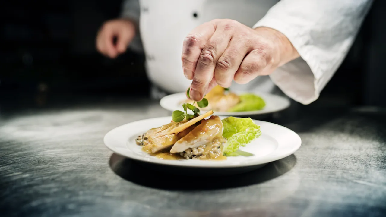 Chef plating a tasting menu dish at one of the best restaurants in Dubai