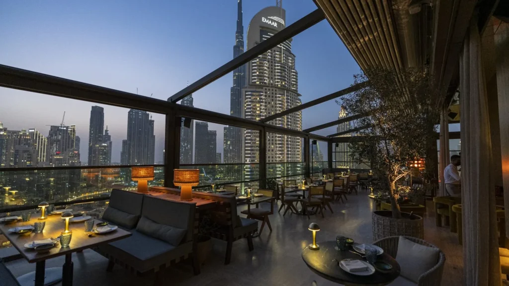 Best restaurants in Dubai: rooftop restaurant at dusk with Burj Khalifa views